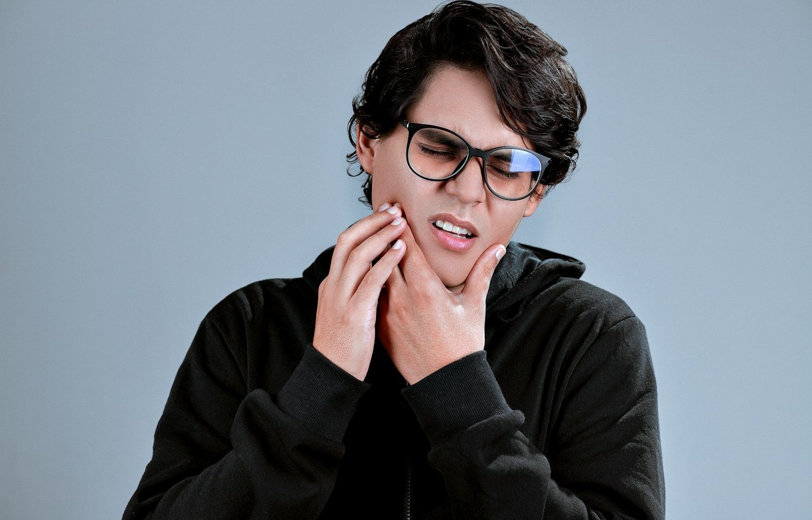 woman in black framed eyeglasses and black long sleeve shirt